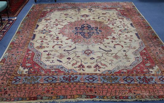 A Turkey pink and cream medallion carpet (worn in places and frayed at one end) 410 x 313cm